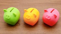 Three brightly-colored piggy banks